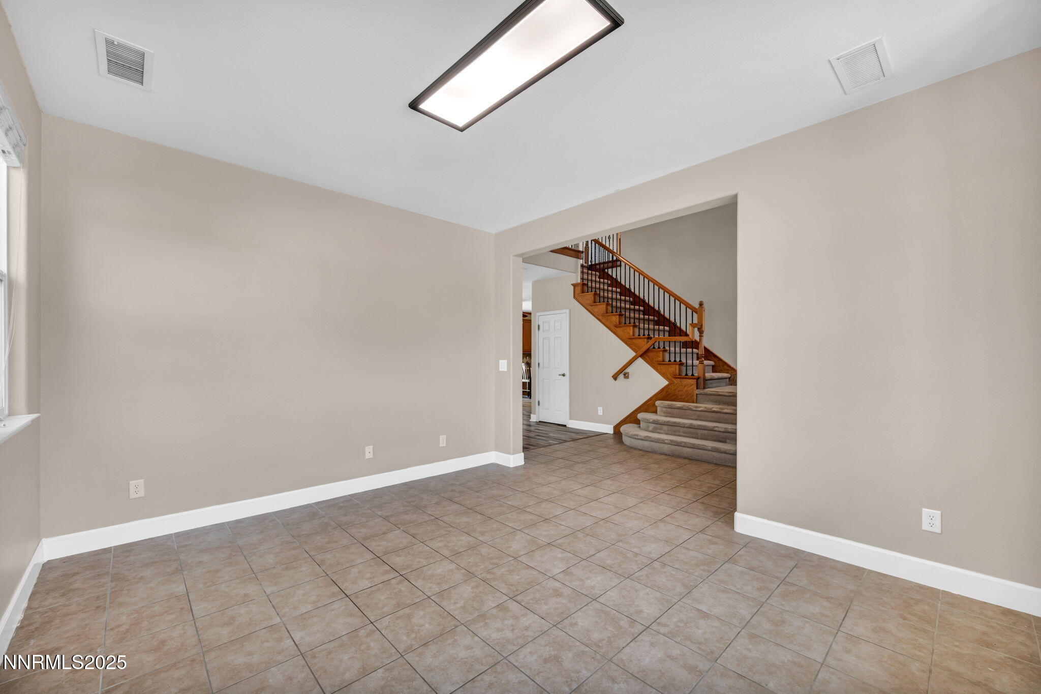 405 Sondrio Court Reno, NV 89521 - Photo 17 of 58 a view of an empty room with stairs