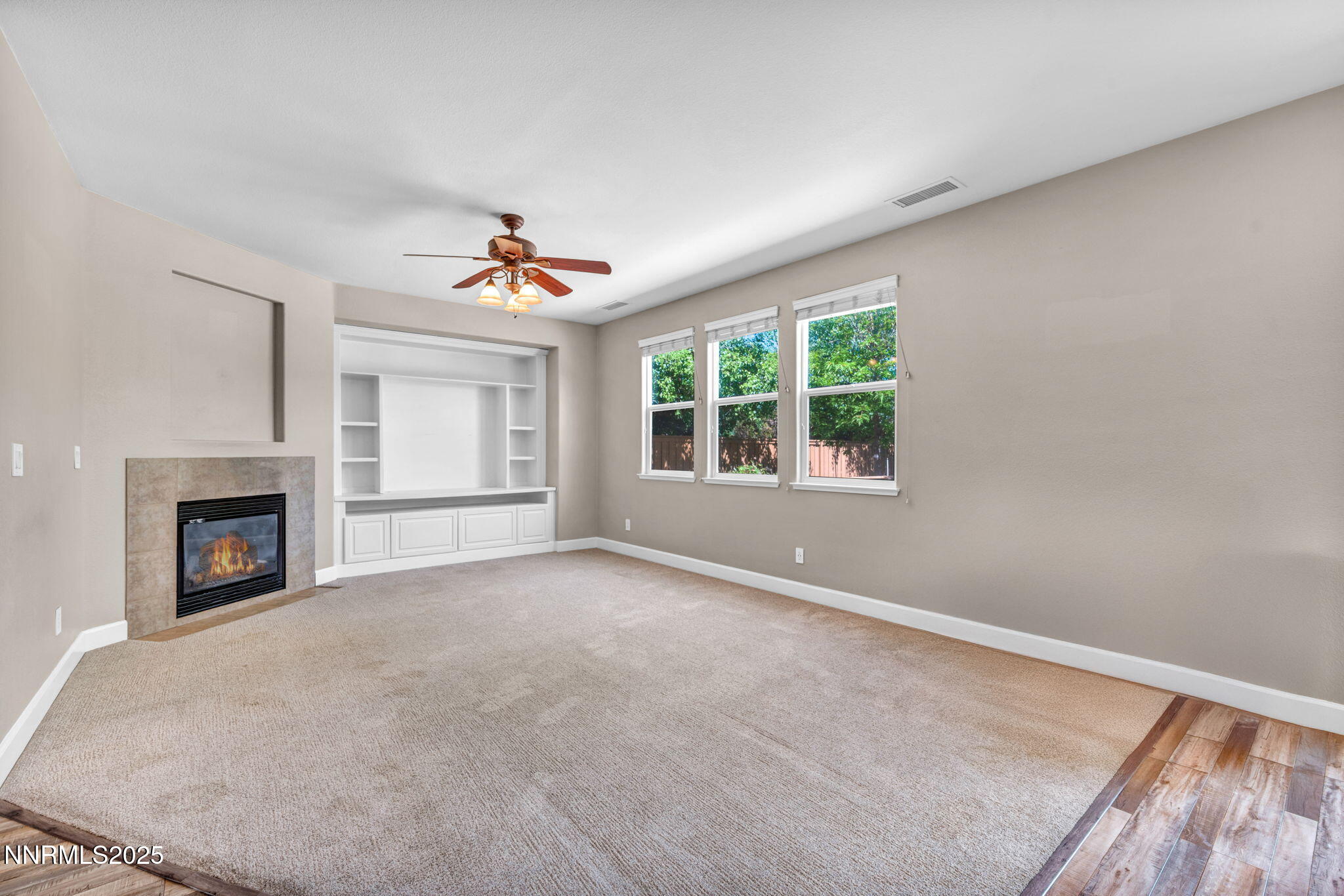 405 Sondrio Court Reno, NV 89521 - Photo 18 of 58 an empty room with windows and a fireplace