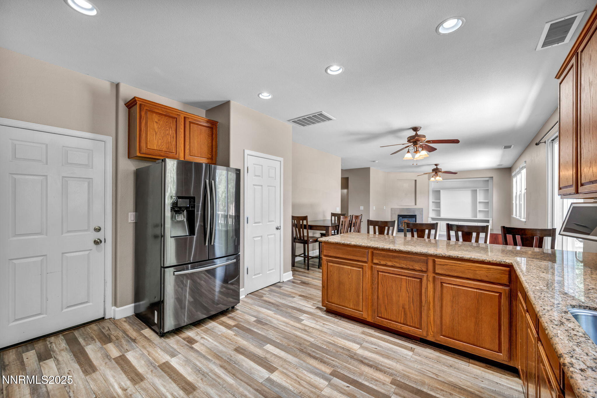 405 Sondrio Court Reno, NV 89521 - Photo 21 of 58 a kitchen with stainless steel appliances granite countertop a refrigerator a stove and a sink