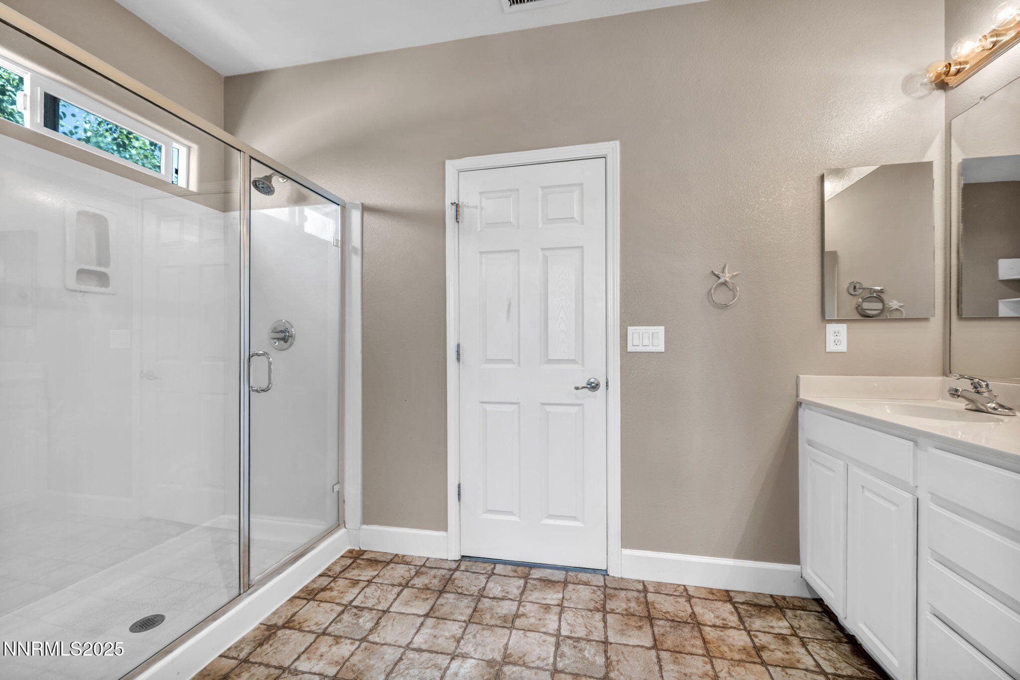 405 Sondrio Court Reno, NV 89521 - Photo 28 of 58 a bathroom with a shower and a sink