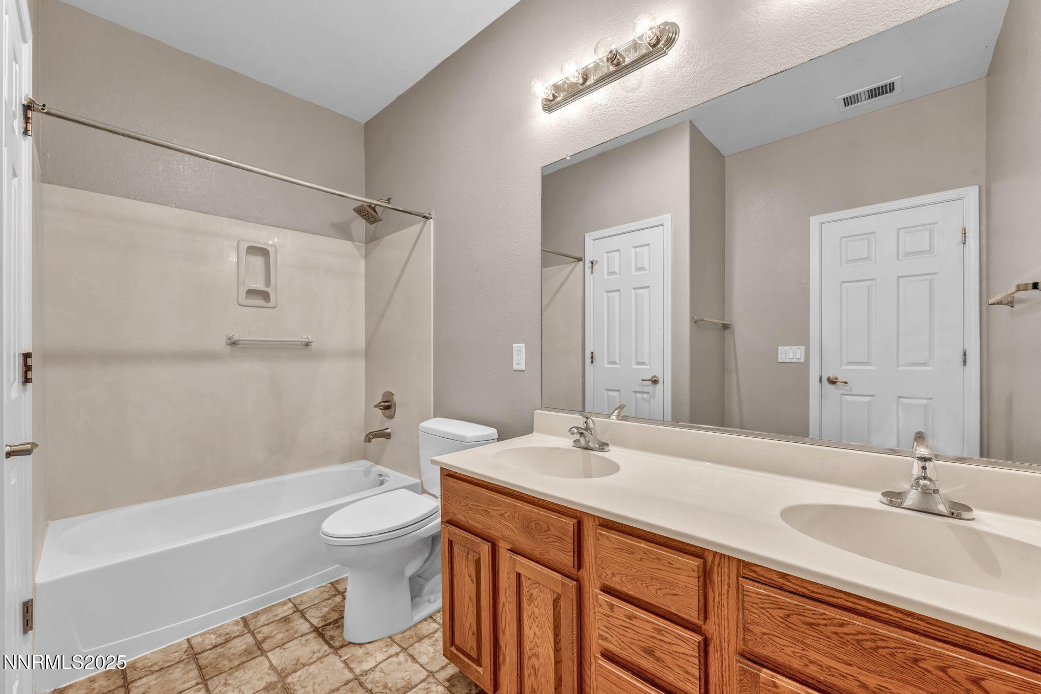 405 Sondrio Court Reno, NV 89521 - Photo 33 of 58 a bathroom with a double vanity sink toilet mirror and bathtub