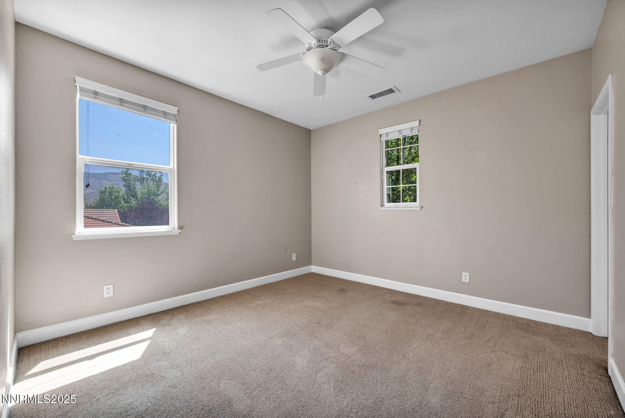 405 Sondrio Court Reno, NV 89521 - Photo 34 of 58 an empty room with a window and a ceiling fan