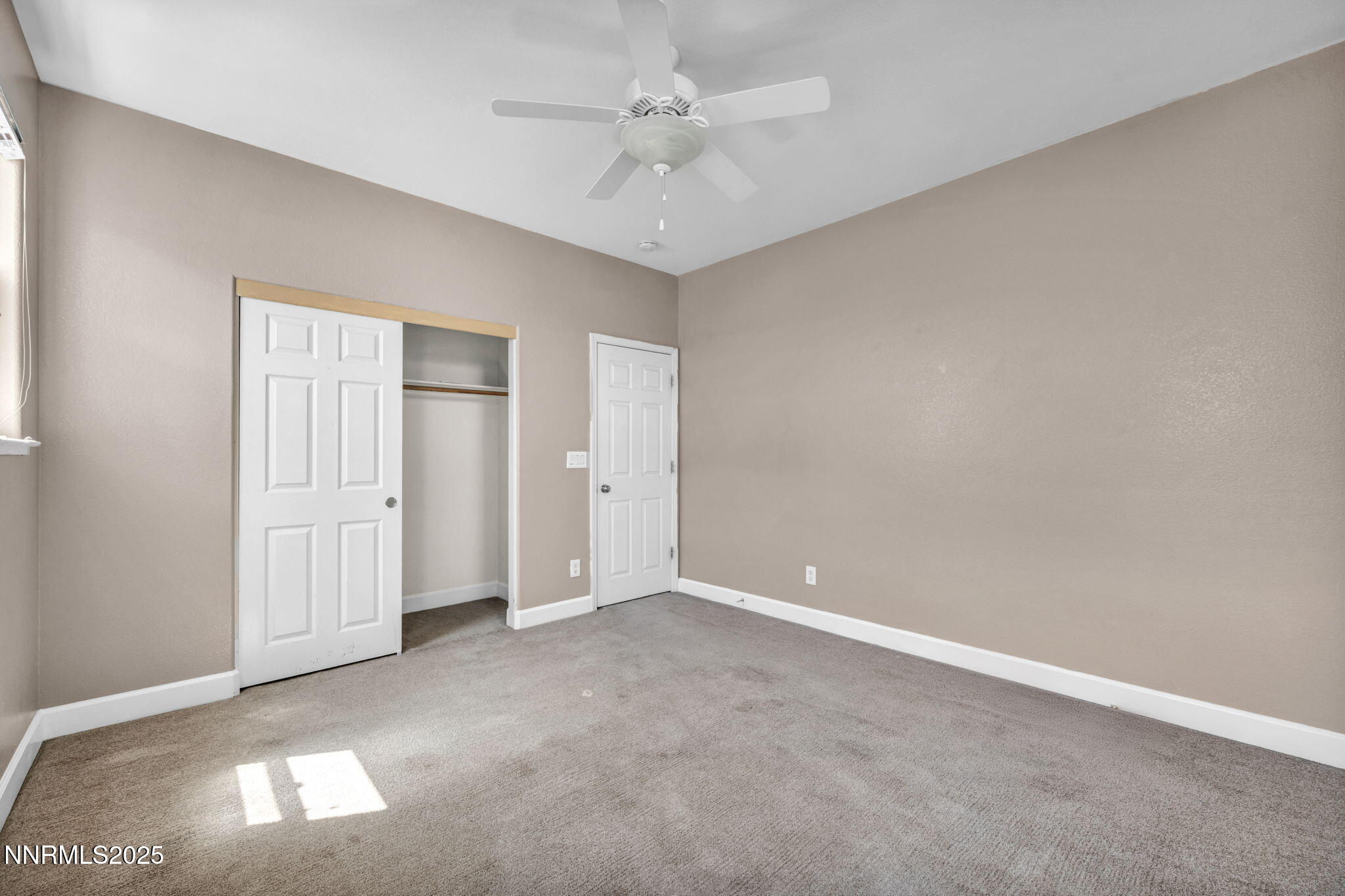 405 Sondrio Court Reno, NV 89521 - Photo 38 of 58 an empty room with windows and ceiling fan