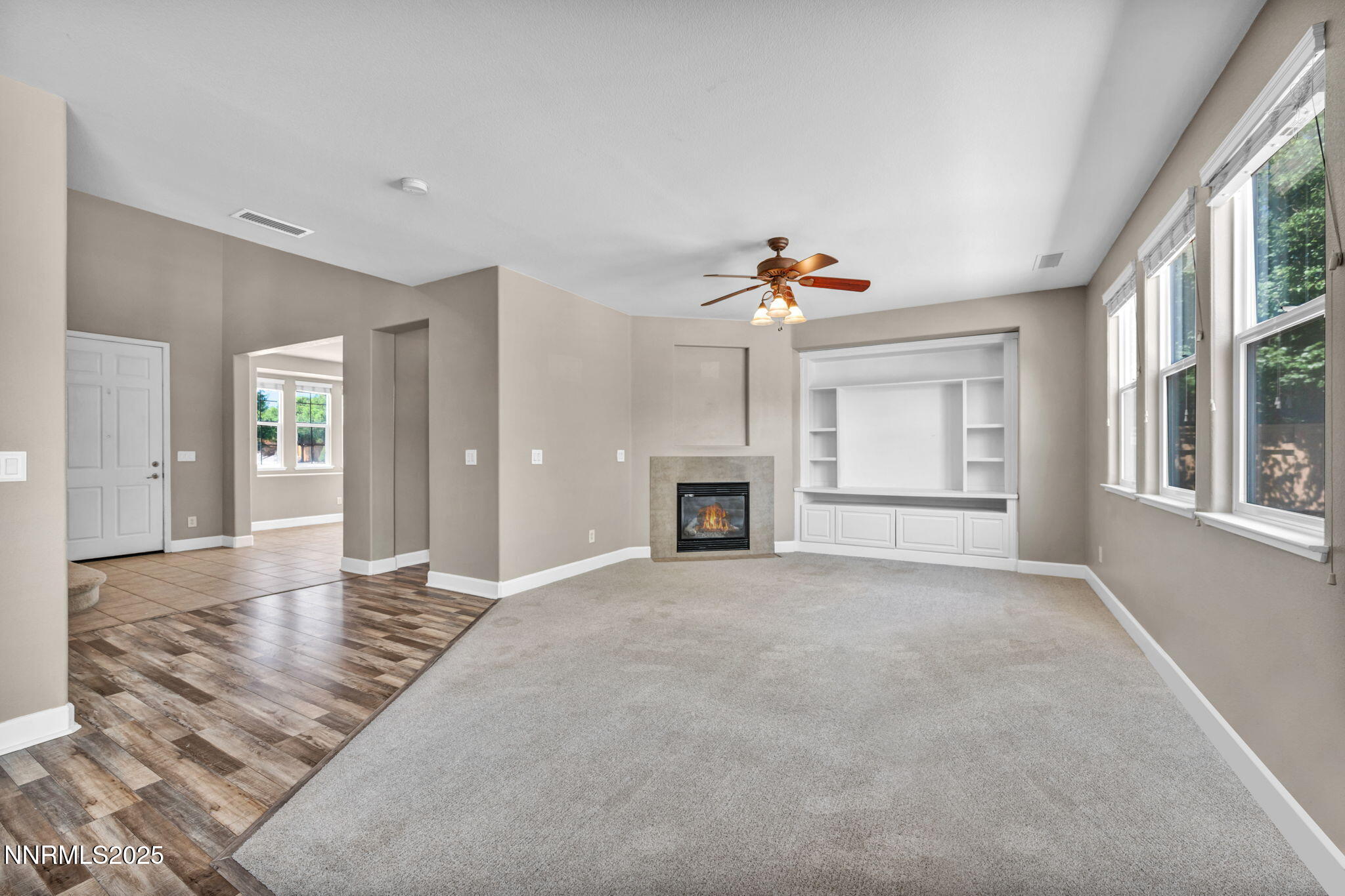 405 Sondrio Court Reno, NV 89521 - Photo 4 of 58 an empty room with windows and fireplace