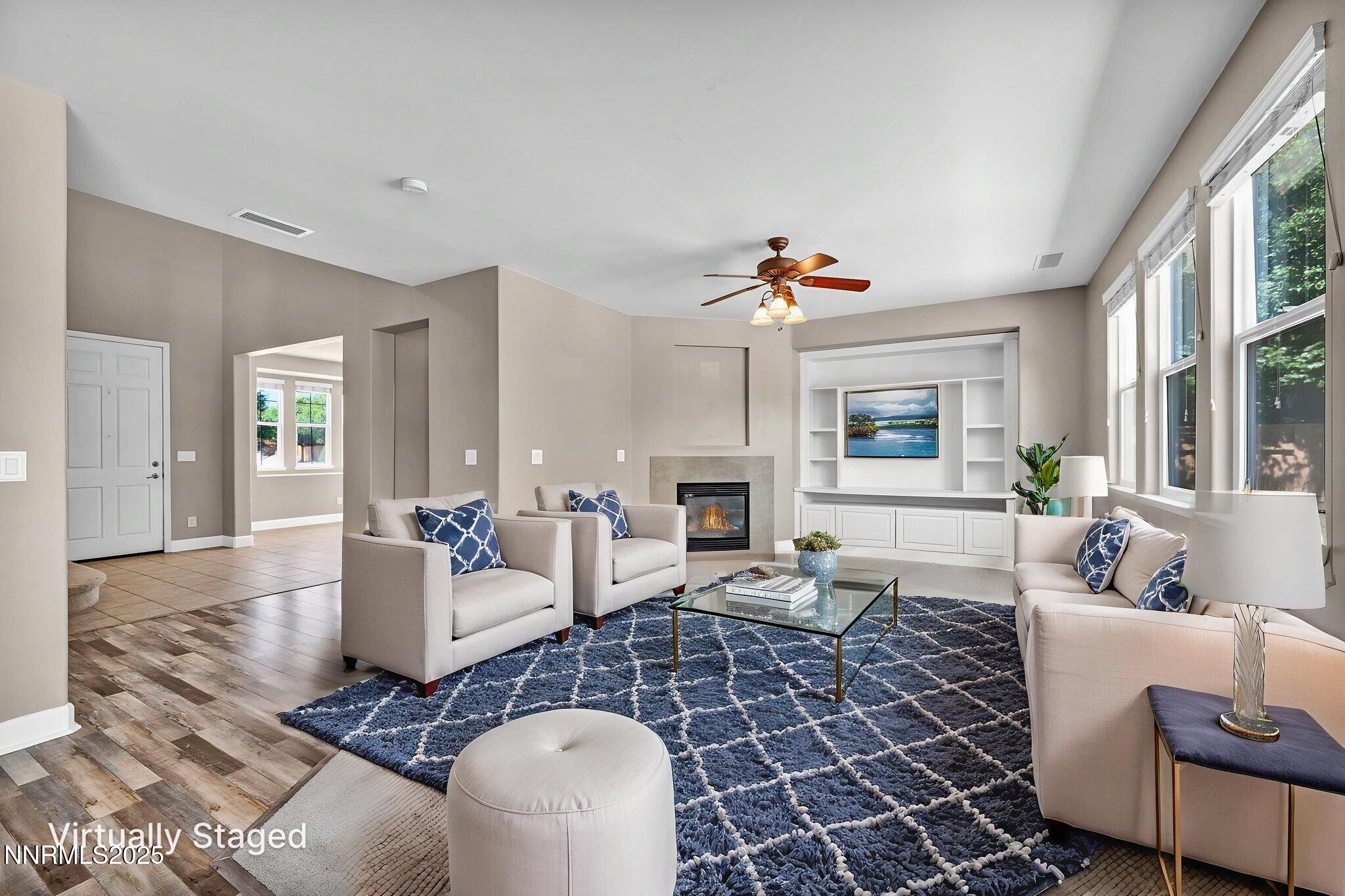 405 Sondrio Court Reno, NV 89521 - Photo 5 of 58 a living room with fireplace furniture and a large window