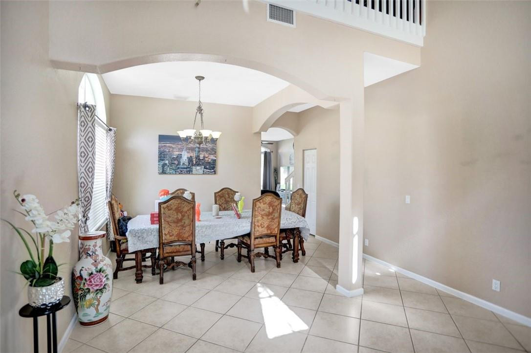 5257 Sancerre Circle Lake Worth, FL 33463 - Photo 11 of 46 a view of a dining room with furniture and a chandelier