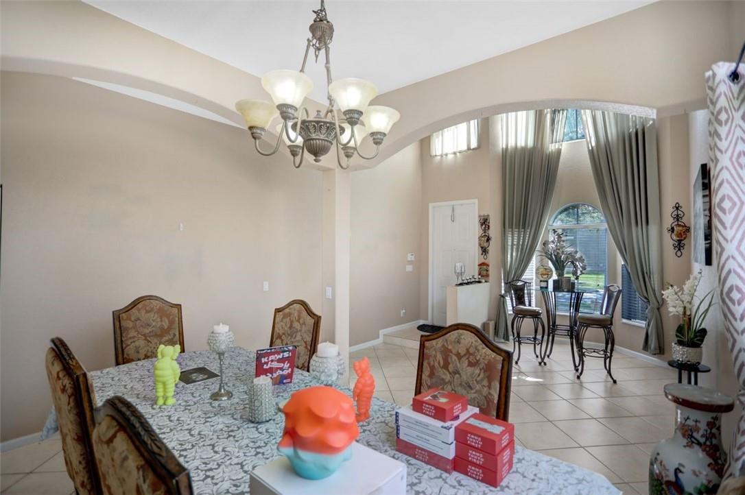 5257 Sancerre Circle Lake Worth, FL 33463 - Photo 12 of 46 a living room with furniture and a chandelier