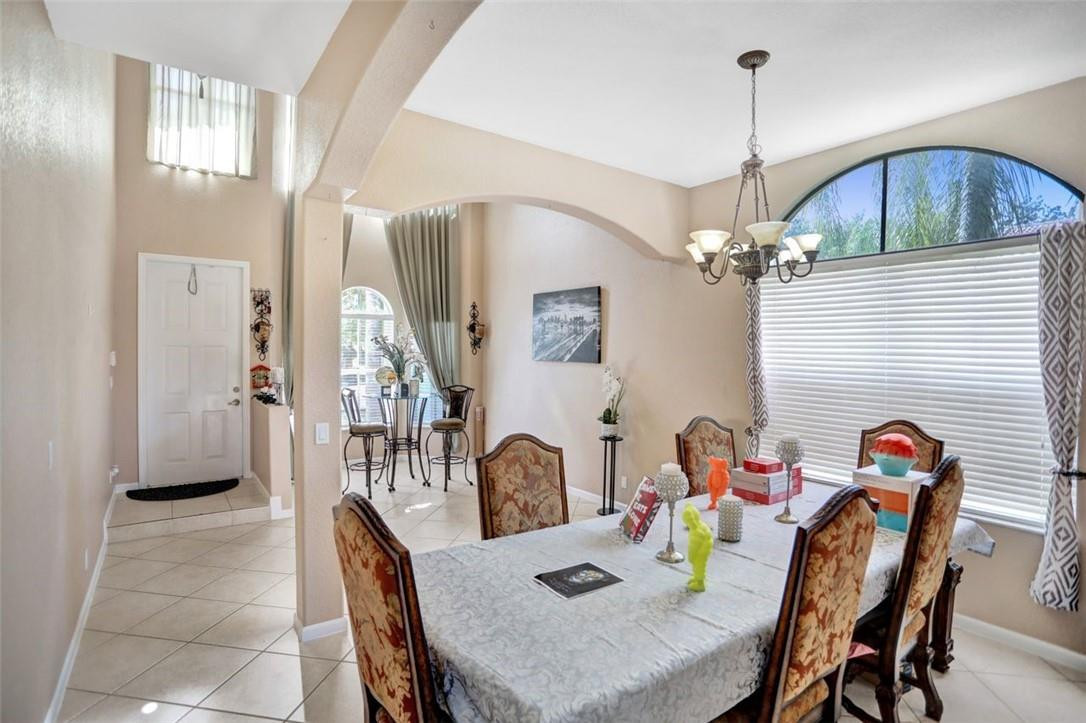 5257 Sancerre Circle Lake Worth, FL 33463 - Photo 13 of 46 a view of a dining room with furniture and chandelier