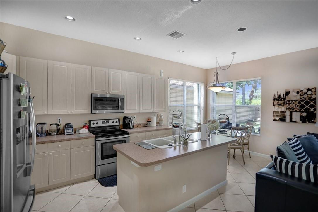 5257 Sancerre Circle Lake Worth, FL 33463 - Photo 15 of 46 a kitchen with sink a microwave and cabinets