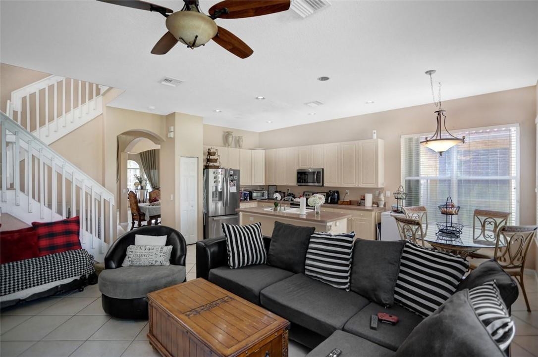 5257 Sancerre Circle Lake Worth, FL 33463 - Photo 17 of 46 a living room with furniture and a chandelier