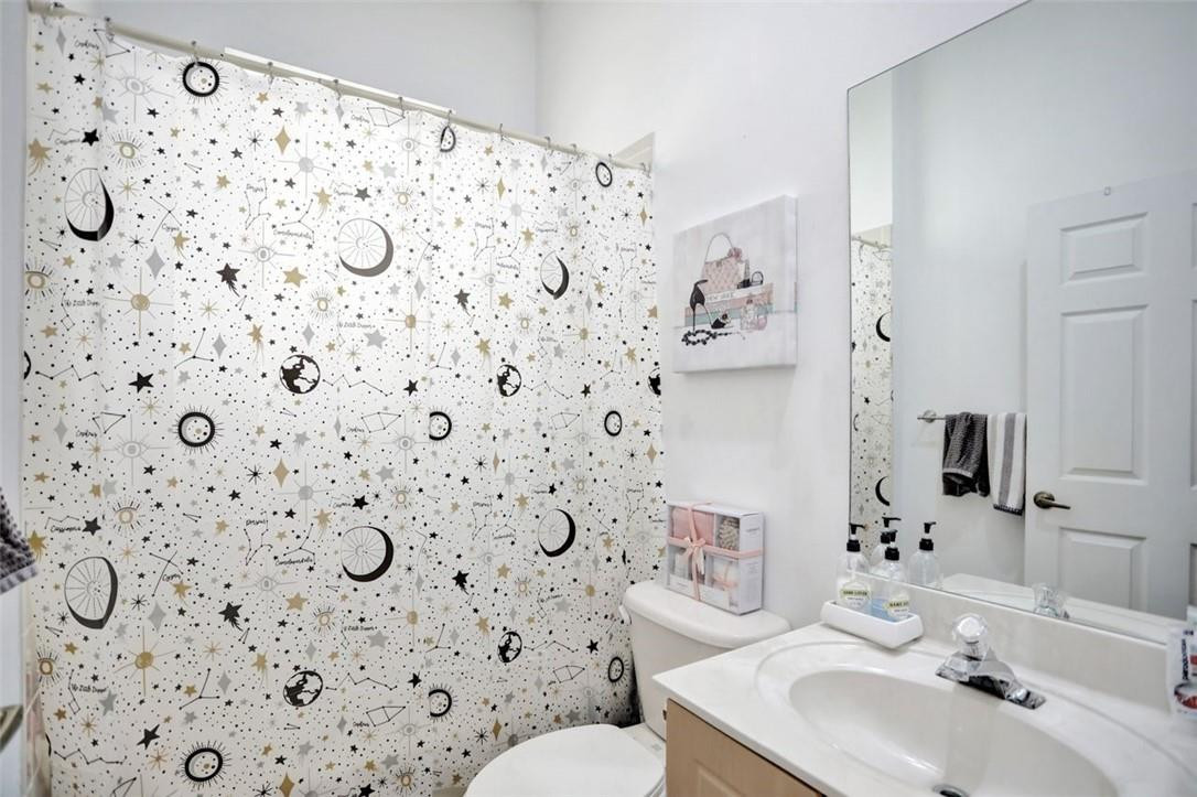 5257 Sancerre Circle Lake Worth, FL 33463 - Photo 21 of 46 a bathroom with a sink toilet and mirror