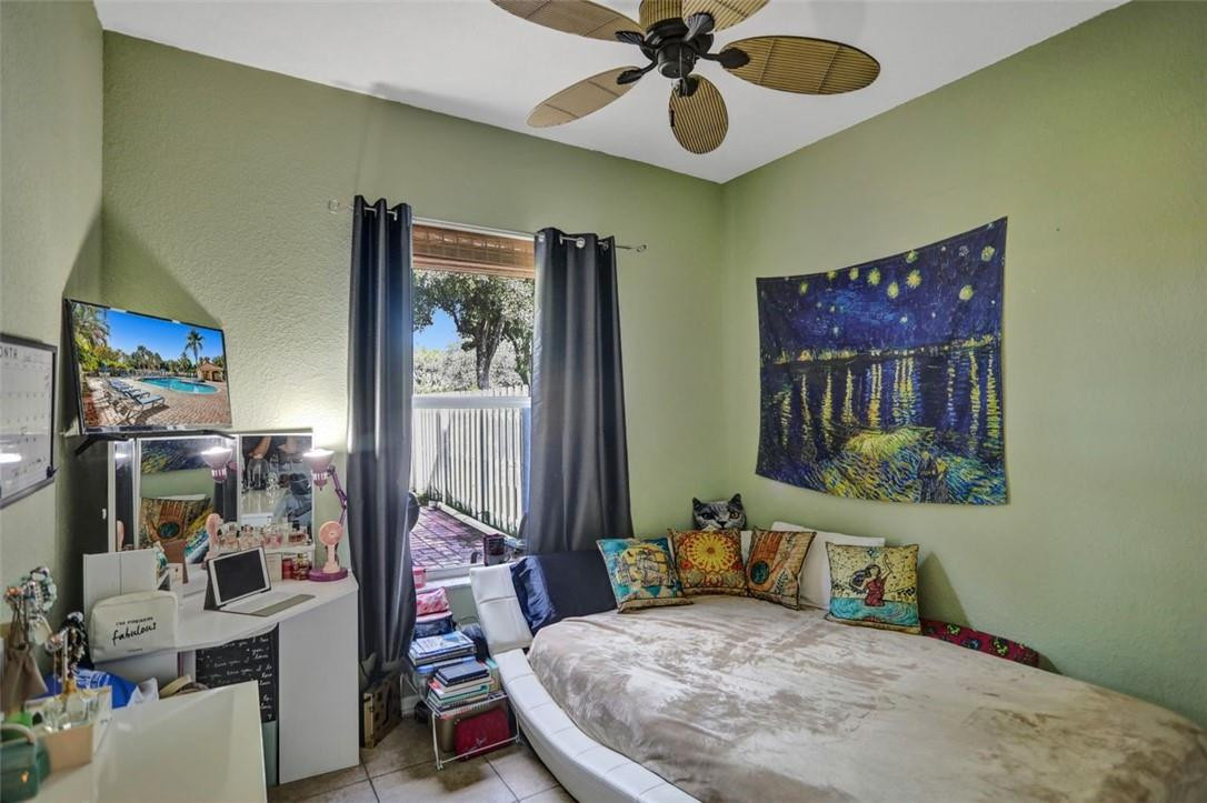 5257 Sancerre Circle Lake Worth, FL 33463 - Photo 22 of 46 a bedroom with a bed and wooden floor