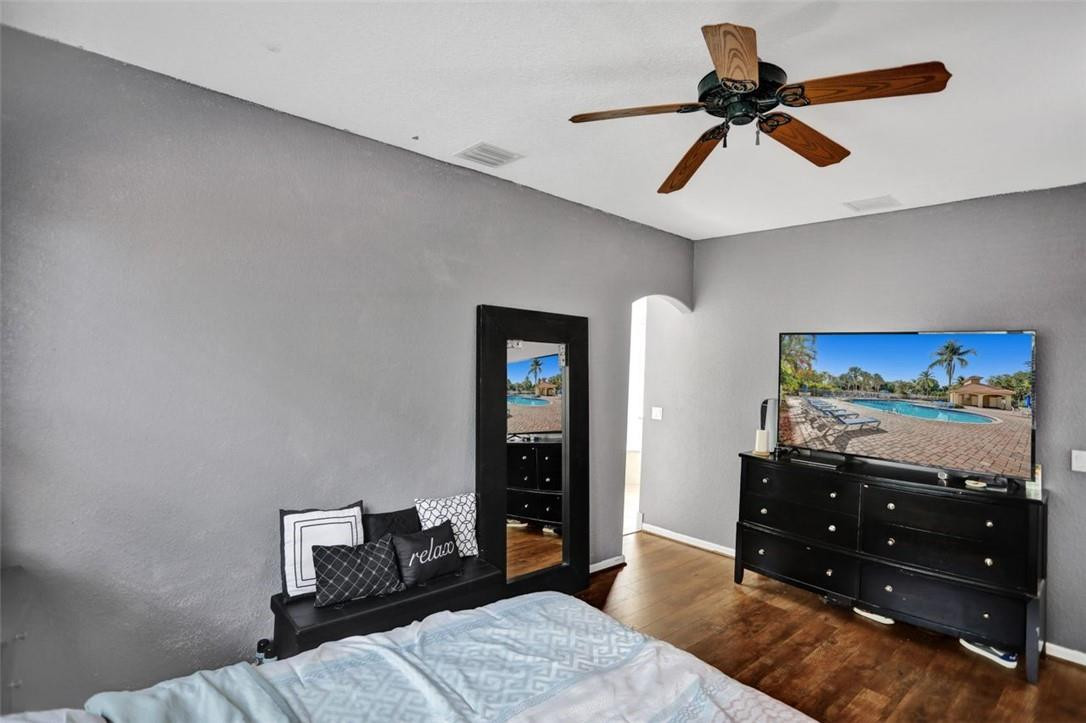 5257 Sancerre Circle Lake Worth, FL 33463 - Photo 27 of 46 a bedroom with a bed and a television