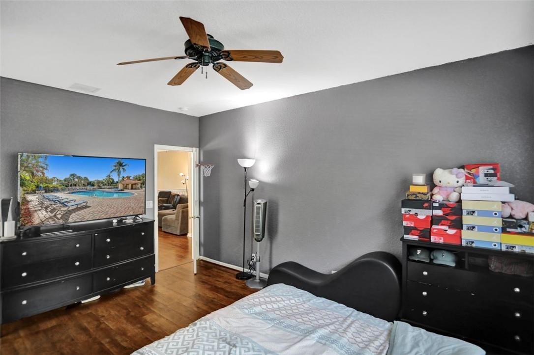 5257 Sancerre Circle Lake Worth, FL 33463 - Photo 28 of 46 a bedroom with a bed and wooden floor