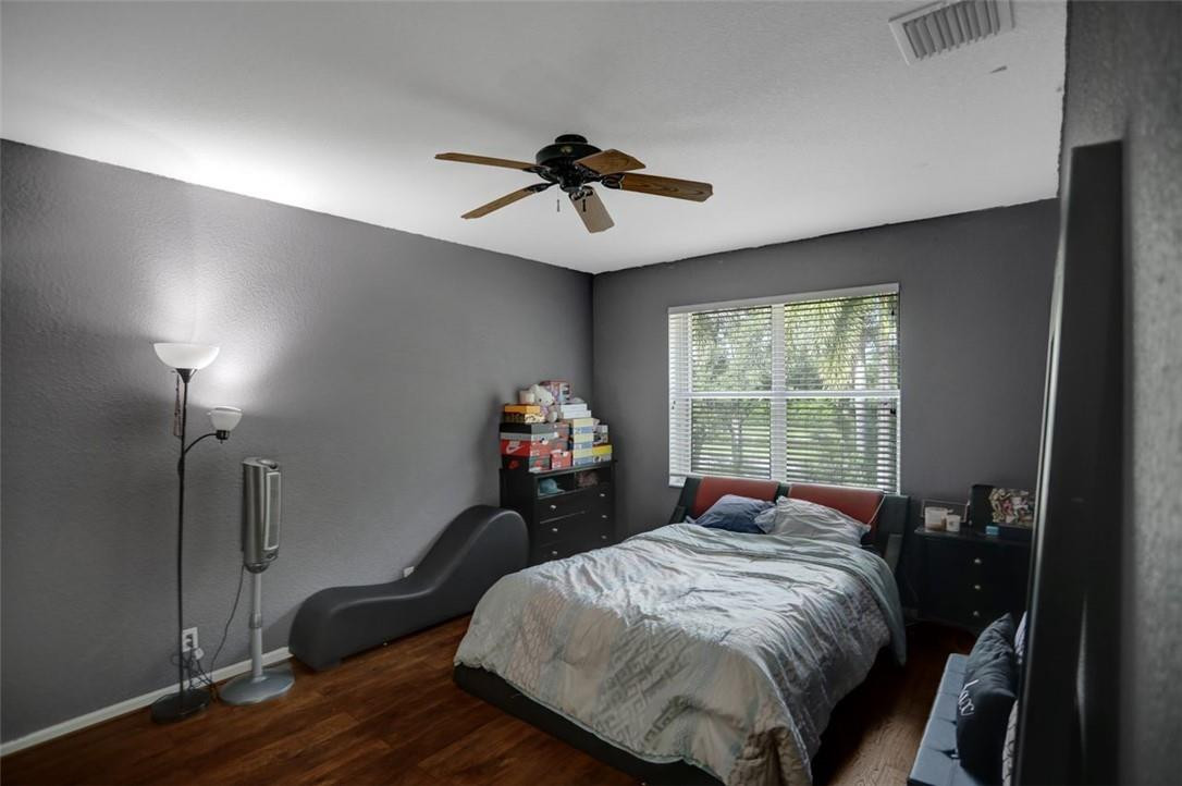 5257 Sancerre Circle Lake Worth, FL 33463 - Photo 29 of 46 a bed sitting in a bedroom next to a window