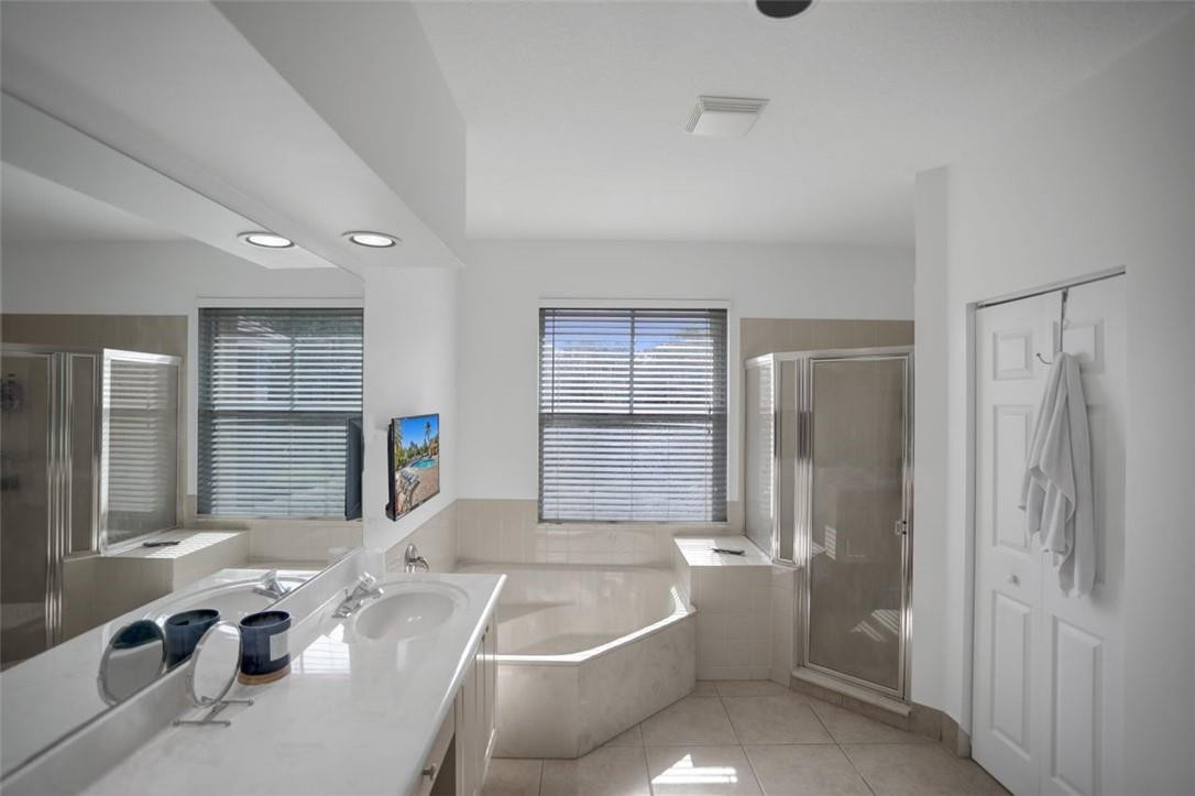 5257 Sancerre Circle Lake Worth, FL 33463 - Photo 31 of 46 a bathroom with a tub a sink and a shower
