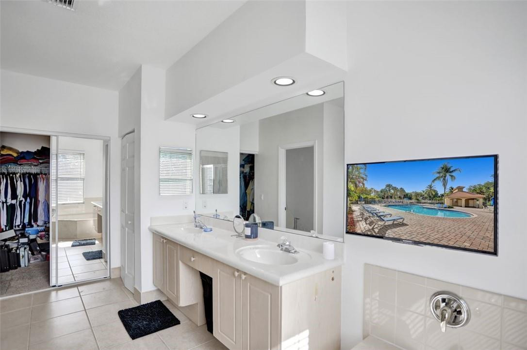 5257 Sancerre Circle Lake Worth, FL 33463 - Photo 32 of 46 a bathroom with a double vanity sink and a mirror