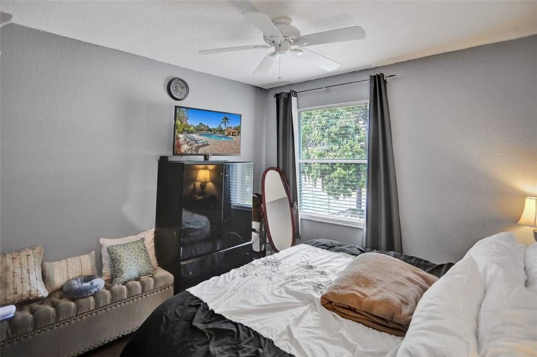5257 Sancerre Circle Lake Worth, FL 33463 - Photo 33 of 46 a bedroom with a bed and a flat screen tv