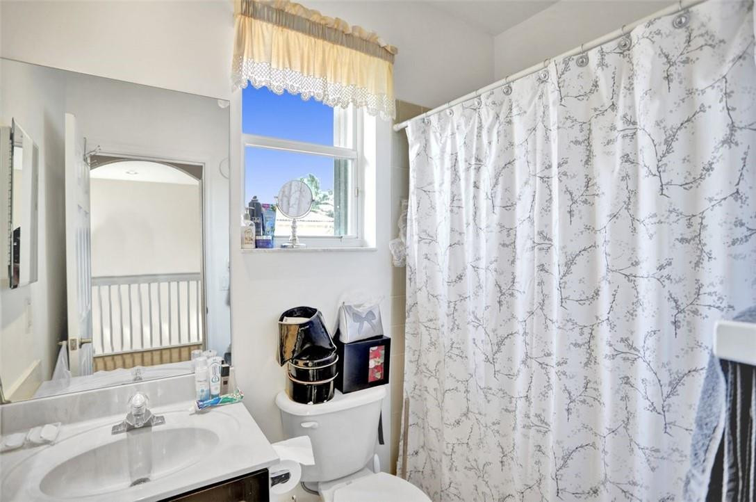 5257 Sancerre Circle Lake Worth, FL 33463 - Photo 36 of 46 a bathroom with a sink a toilet and shower curtain