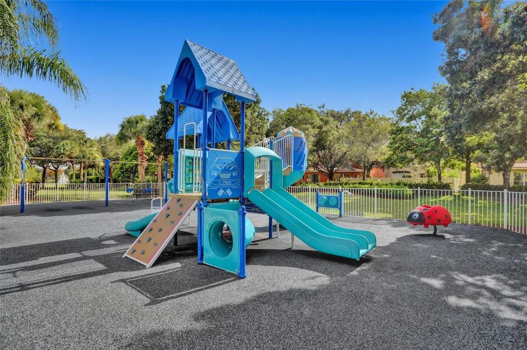 5257 Sancerre Circle Lake Worth, FL 33463 - Photo 40 of 46 a childrens park with lots of swings and slides