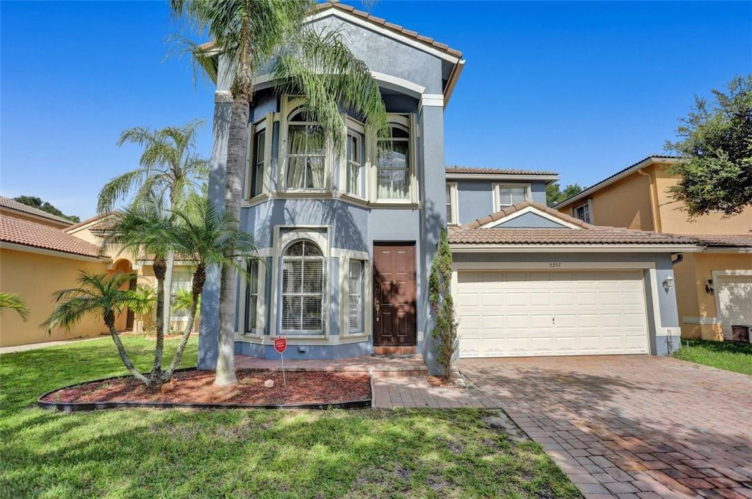 5257 Sancerre Circle Lake Worth, FL 33463 - Photo 4 of 46 a front view of a house with a yard