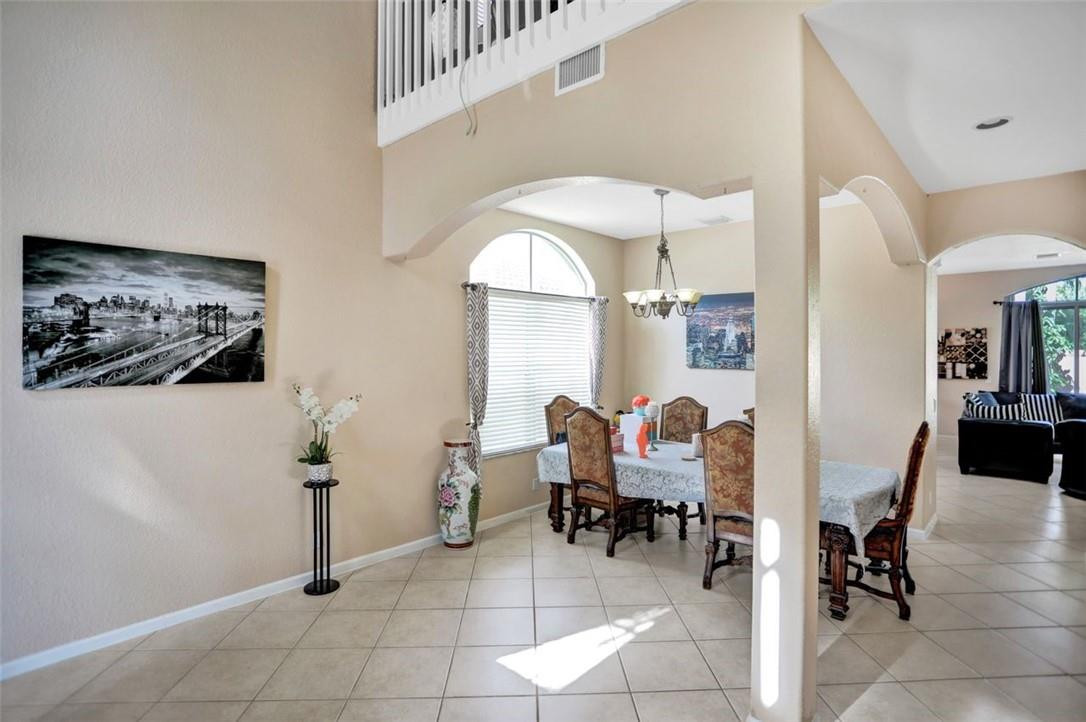 5257 Sancerre Circle Lake Worth, FL 33463 - Photo 9 of 46 a dining room with furniture and a large window