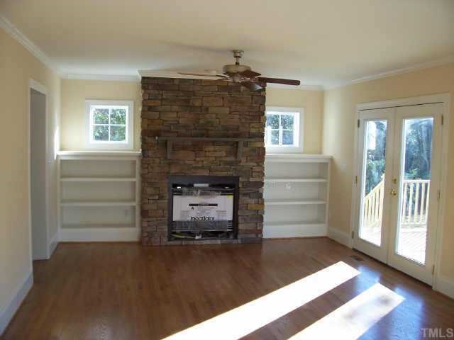 813 Chamberlain Street Raleigh, NC 27607 - Photo 4 of 9 a living room with furniture and a fireplace