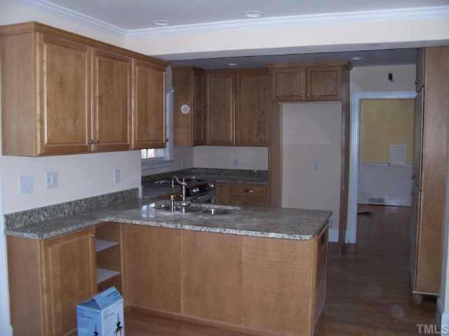 813 Chamberlain Street Raleigh, NC 27607 - Photo 5 of 9 a kitchen with sink cabinets and window