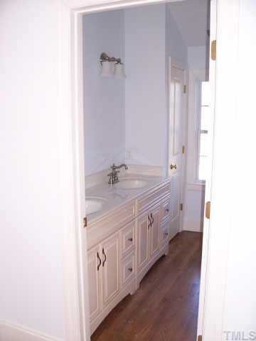 813 Chamberlain Street Raleigh, NC 27607 - Photo 7 of 9 a spacious bathroom with a granite countertop sink and a
