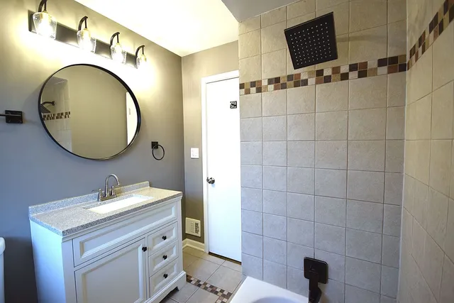 a bathroom with a sink a mirror and a toilet