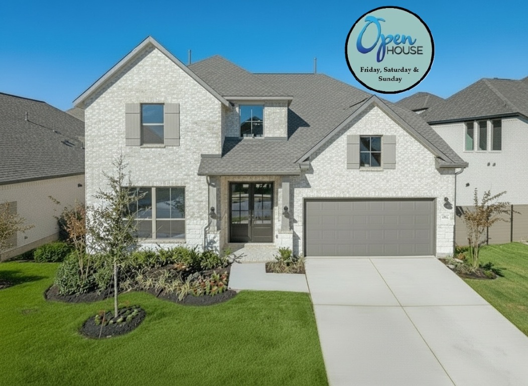 View of front of house with brick siding, concrete driveway, and a front yard
