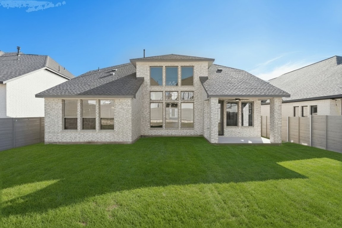 1528 Rodeo Ridge Drive Georgetown, TX 78628 - Photo 21 of 28 Back of property with a fenced backyard, brick siding, a patio area, and roof with shingles
