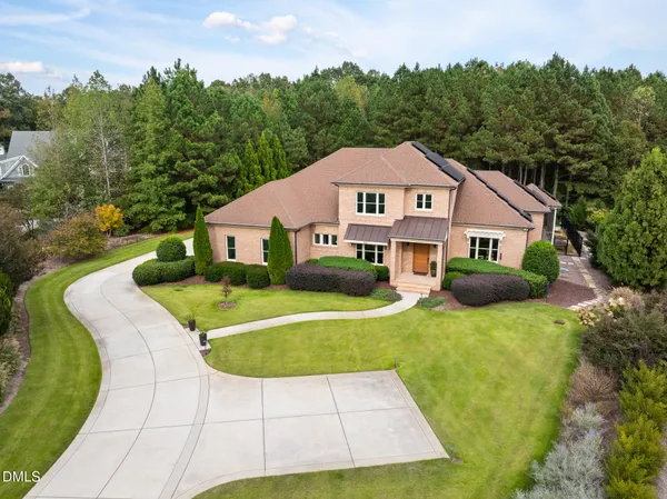 a front view of a house with a yard table and chairs