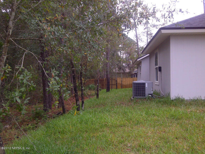 97236 Bluff View Circle Yulee, FL 32097 - Photo 5 of 60 a view of backyard with trampoline