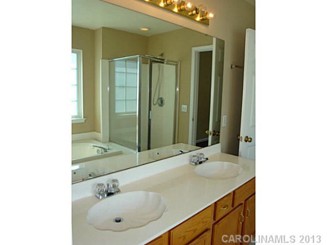 3741 Marbury Road Charlotte, NC 28269 - Photo 11 of 16 a bathroom with a sink and a mirror