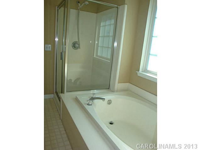 3741 Marbury Road Charlotte, NC 28269 - Photo 12 of 16 a bathroom with a tub and shower