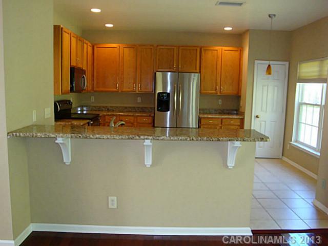 3741 Marbury Road Charlotte, NC 28269 - Photo 5 of 16 a bathroom with a sink a mirror and a shower