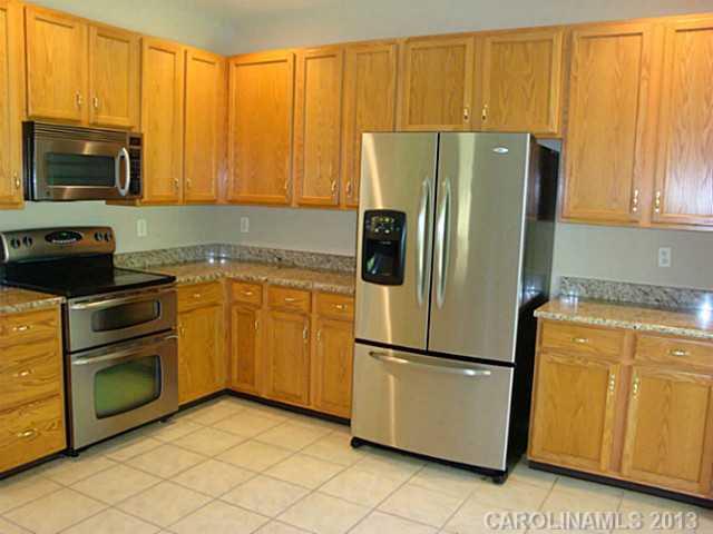 3741 Marbury Road Charlotte, NC 28269 - Photo 6 of 16 a kitchen with a refrigerator sink and microwave
