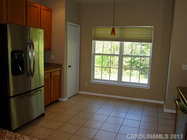 3741 Marbury Road Charlotte, NC 28269 - Photo 8 of 16 a kitchen with stainless steel appliances granite countertop a refrigerator and a refrigerator