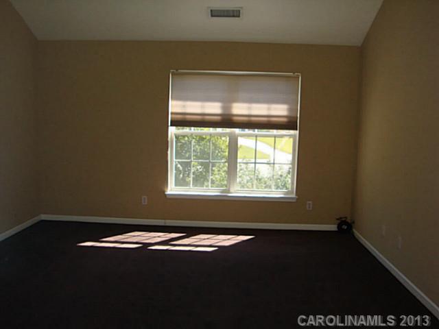 3741 Marbury Road Charlotte, NC 28269 - Photo 9 of 16 an empty room with a window