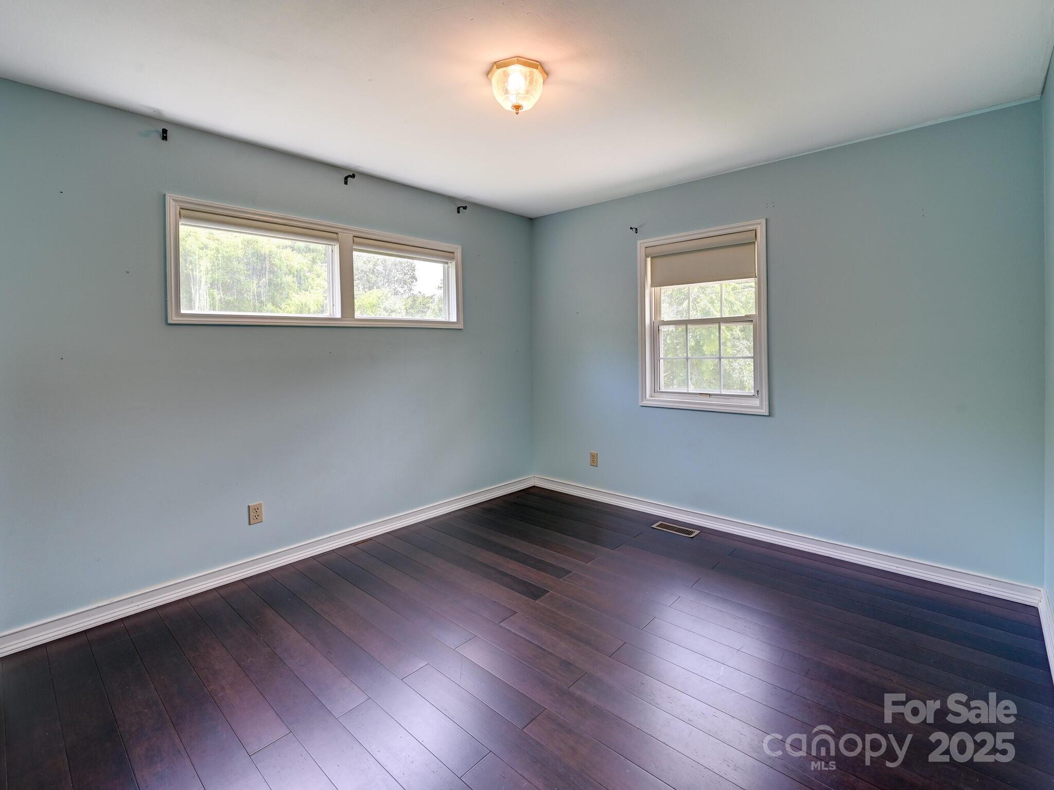 14 Spring Lake Drive Fletcher, NC 28732 - Photo 19 of 29 a view of an empty room with wooden floor and a window