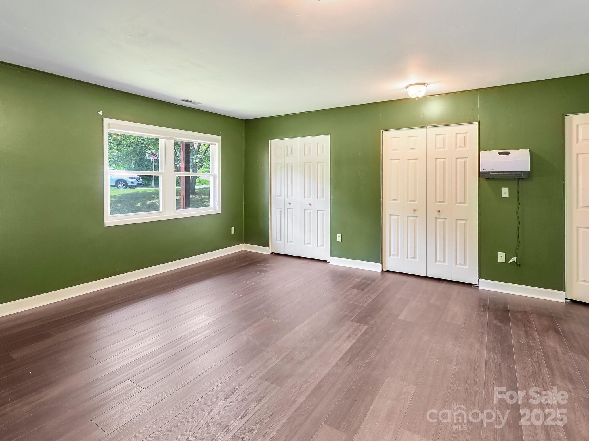 14 Spring Lake Drive Fletcher, NC 28732 - Photo 21 of 29 an empty room with wooden floor and windows