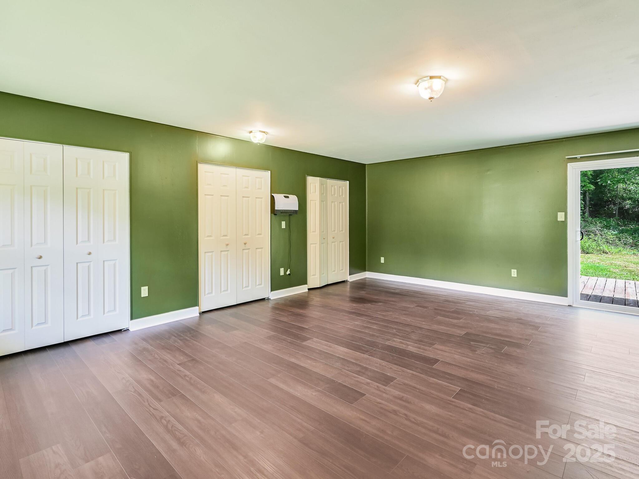 14 Spring Lake Drive Fletcher, NC 28732 - Photo 22 of 29 an empty room with wooden floor and windows
