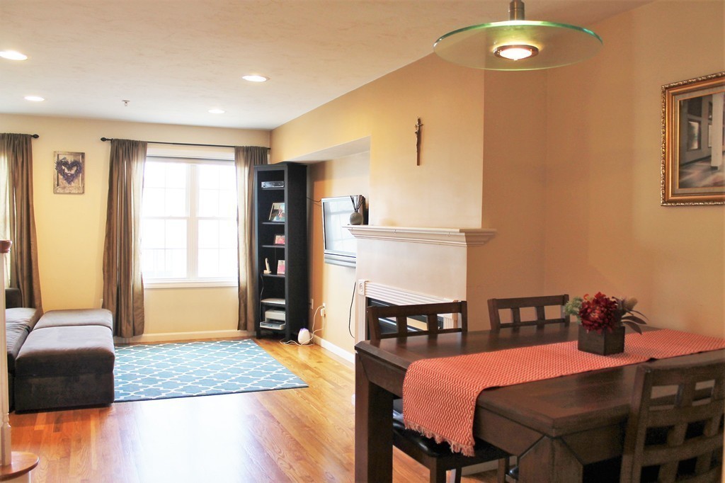 47 Alder Street, Unit 9 Waltham, MA 02453 - Photo 6 of 23 a bedroom with a bed and a chandelier