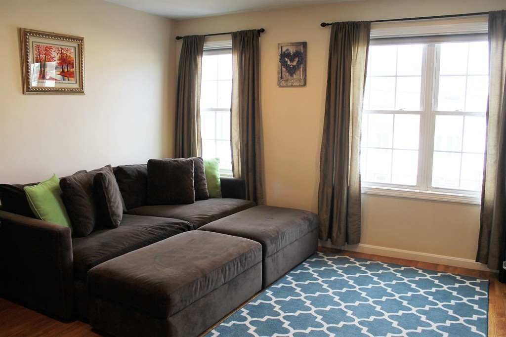 47 Alder Street, Unit 9 Waltham, MA 02453 - Photo 8 of 23 a living room with furniture and a window