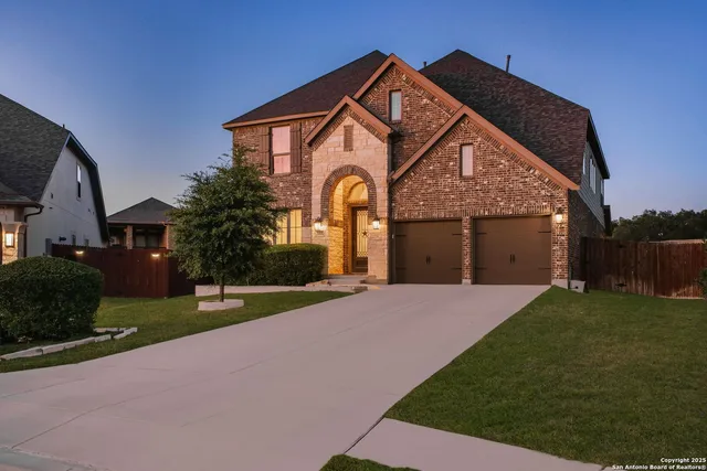 a front view of a house with a yard and garage