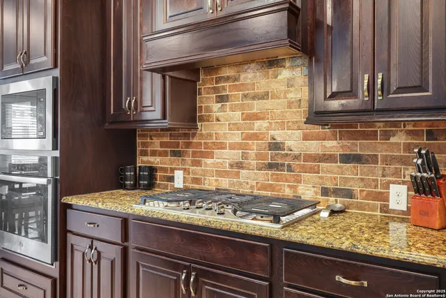 a stove top oven sitting inside of a kitchen