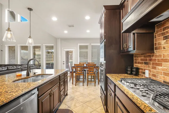 a kitchen with kitchen island granite countertop a sink and counter space
