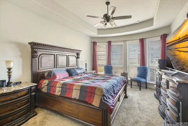 a bedroom with a large bed and a chandelier