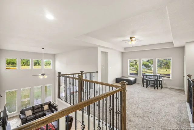 a view of a room with furniture and windows